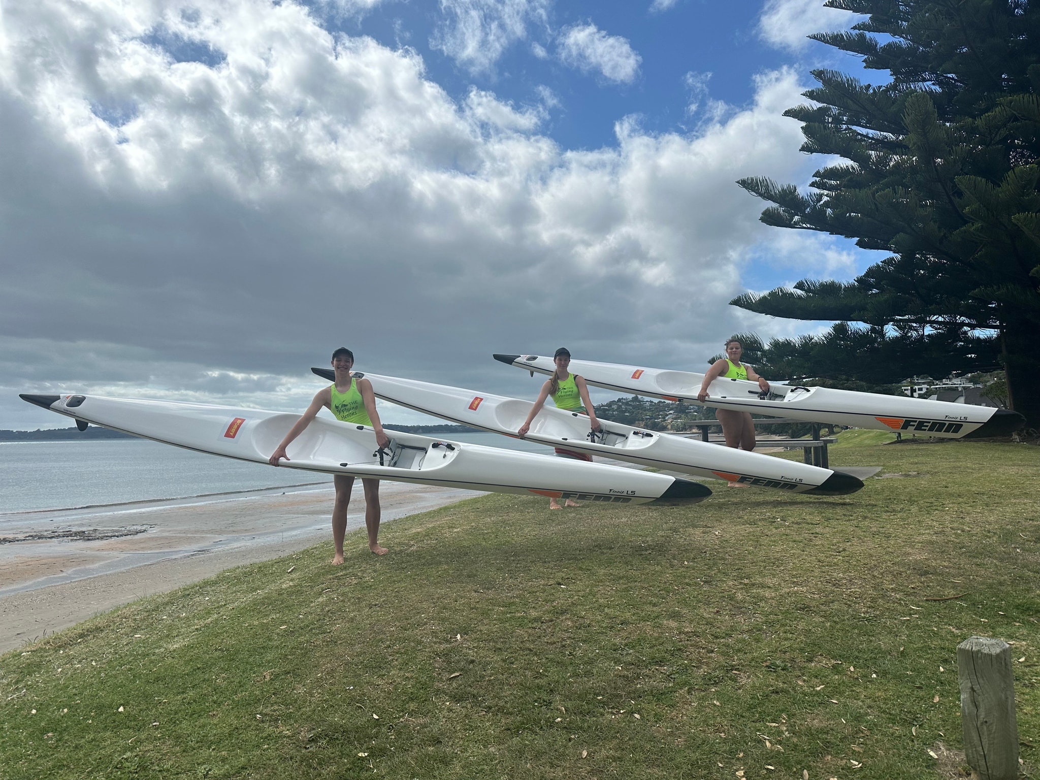 Three women holding surf skis